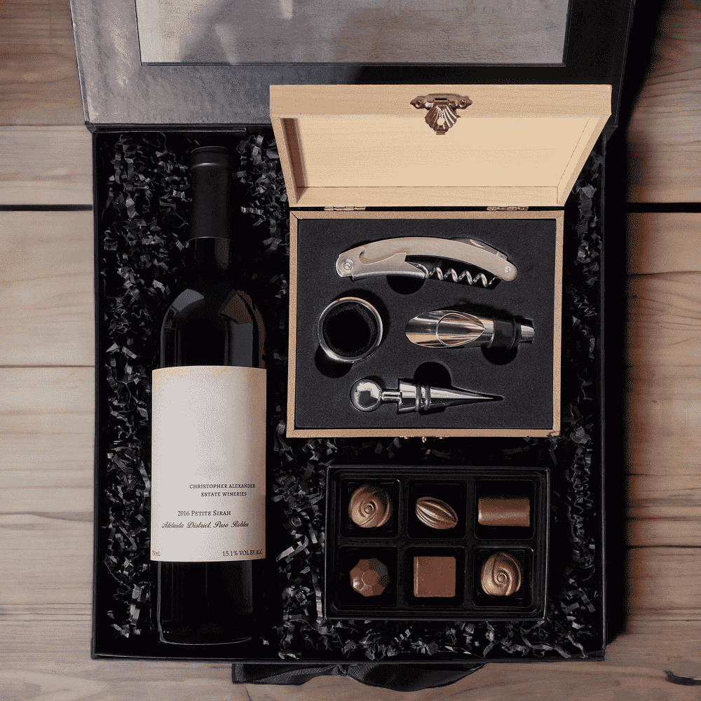 A Wine Connoisseur's Joy Gift Set of Bottle of Wine, Chocolate, Wine Tools, and Large Black Hinged Box.