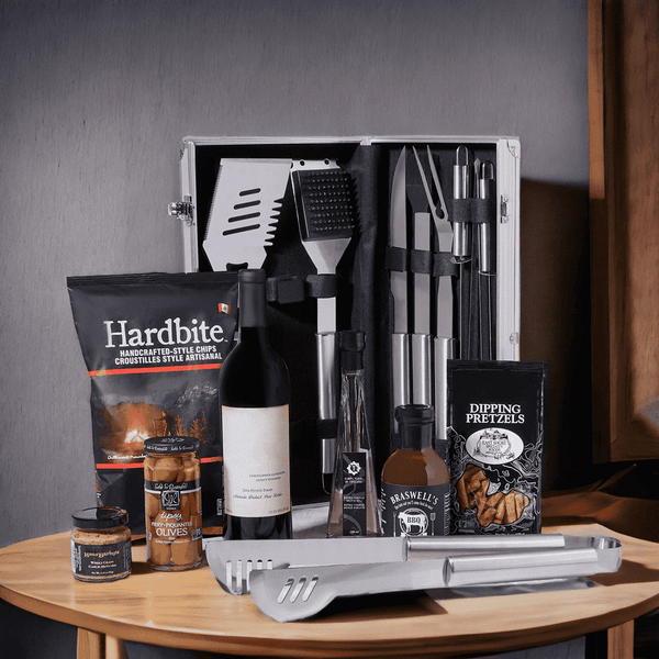 BBQ Time! Gift Basket with Wine features: A bottle of Wine, Mustard, BBQ Sauce, Olive Oil, Hardbite Smokin' BBQ Chips, Pretzels, Olives, & a Grilling Tools Set.