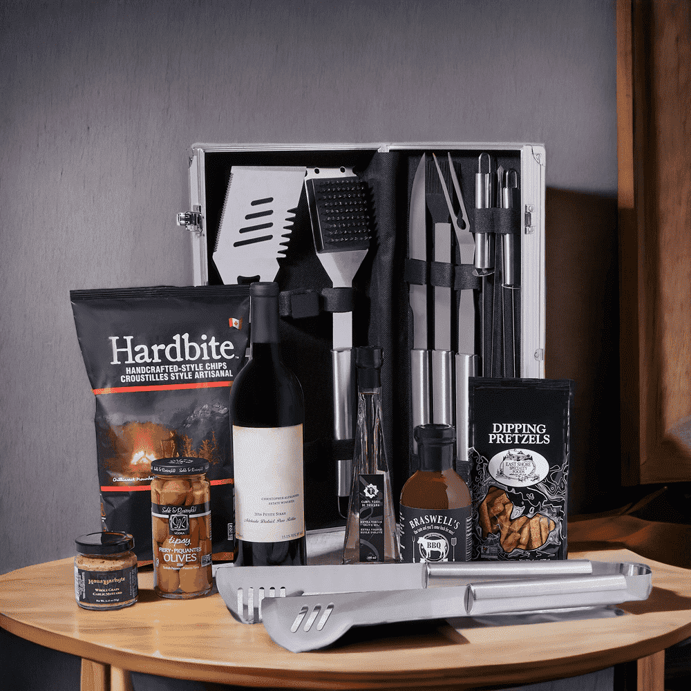 BBQ Time! Gift Basket with Wine features: A bottle of Wine, Mustard, BBQ Sauce, Olive Oil, Hardbite Smokin' BBQ Chips, Pretzels, Olives, & a Grilling Tools Set.