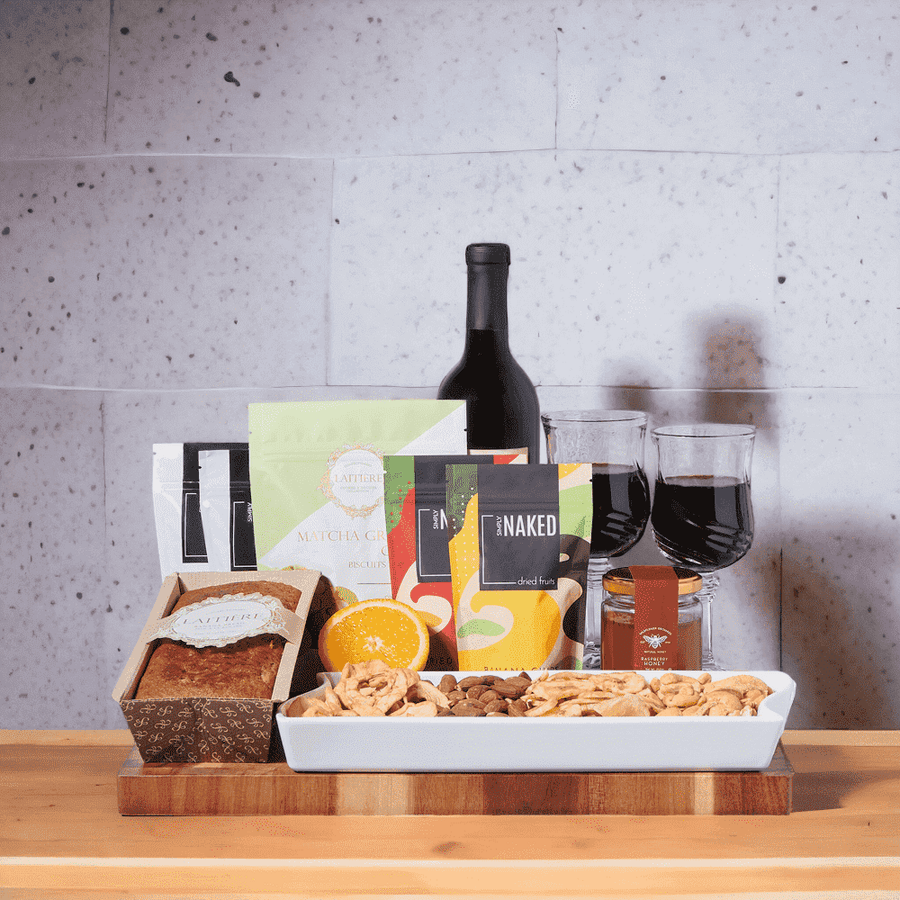 Family get-togethers! The Banana Loaf, Dried Fruits, & Nuts Gift Set features: Wine, Dried Fruit, Nuts, LaitiAre Banana Loaf, Cookies, Lucca Plate Dish, 2 Fontana (Wine Glasses), & a Large Acacia End Grain Cutting Board. 