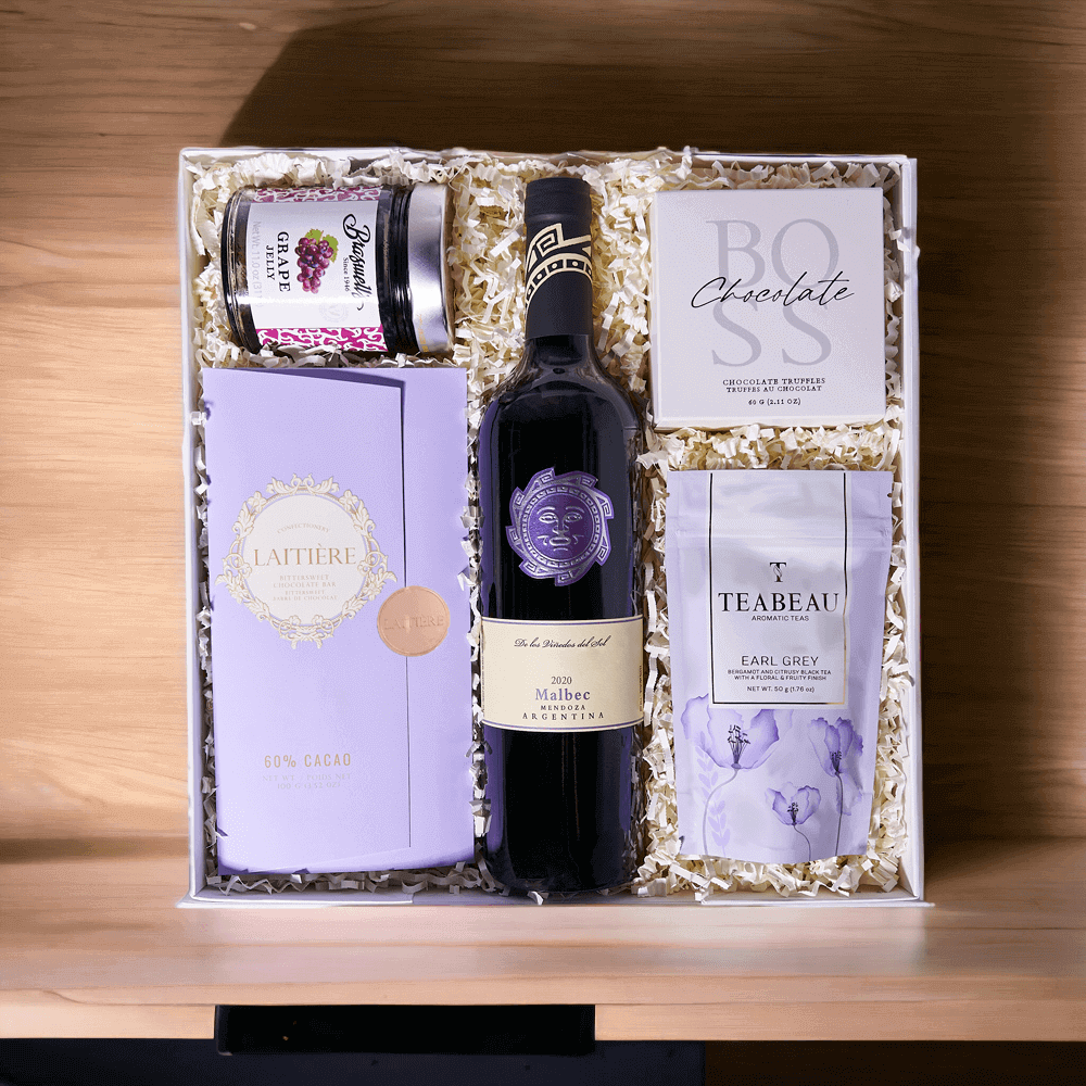 "Mother's Day Wine Gift Basket" The perfect gift for Mother's Day! Features a selection of delicious chocolate truffles, Earl Grey tea, grape jelly, a bar of chocolate, and a bottle of wine.