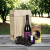 The Superb Wine & Jam Gift from Monthly Sommelier features a bottle of wine, crackers, grapes, and jam. 