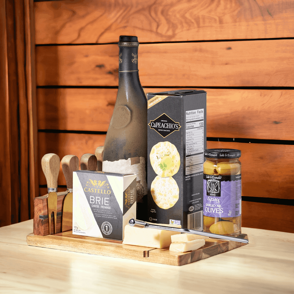 The Delightful Wine & Cheese Board is the perfect gift for any occasion. Featuring rich cheeses, a bottle of fine wine, garlic olives, crackers, and a full cheese serving board with four cheese knives.