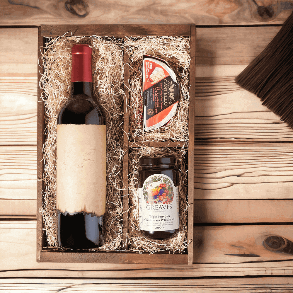 This gift set features a bottle of wine, creamy brie cheese with chili, triple berry jam, and a wooden wine box. You are sure to delight your loved ones with this charming and thoughtful present. 