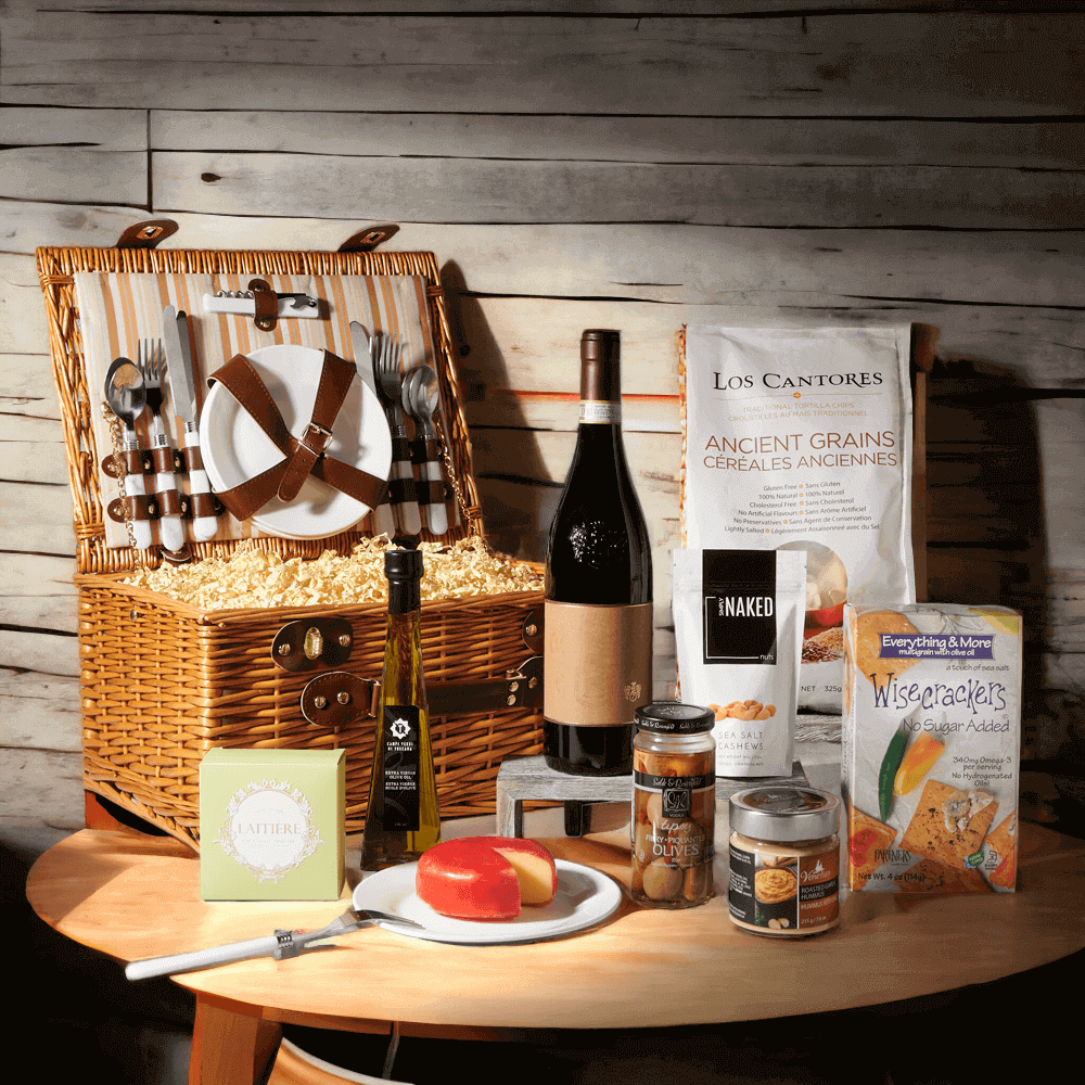The picnic basket has a full set of tableware so you can enjoy a wonderful picnic meal wherever you please! Featured in this gift is a selection of gourmet goodies including olive oil, olives, hummus, crackers, chips, cashews, decadent assorted chocolate truffles, and cheese.